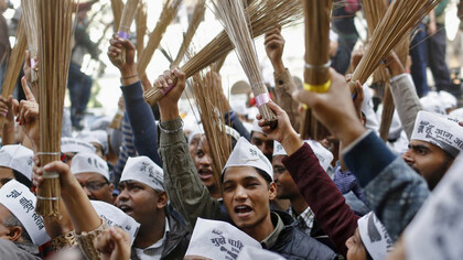 AAP followers waving brooms