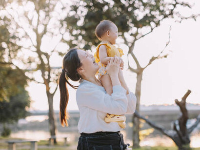 A South Korean mother holding her baby, reflecting the country's demographic challenges amid the ongoing population decline and fertility crisis
