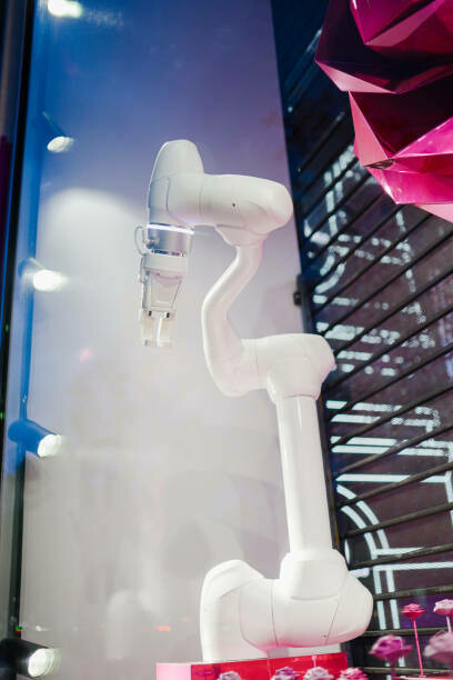 The robotic flower installation showcases a robot arm picking and handing over a plastic rose, blending AI and floral design with industrial robots performing delicate rose-picking tasks