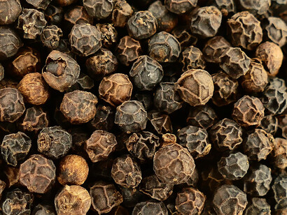 A handful of black peppercorns