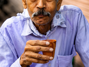 Local resident sipping chai on a quiet street in Jaipur, India
