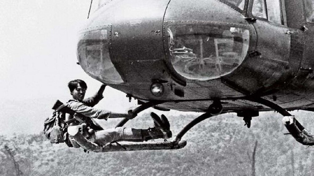 ARVN soldier clings to a departing helicopter while fleeing the Khe Sanh base, March 20, 1971