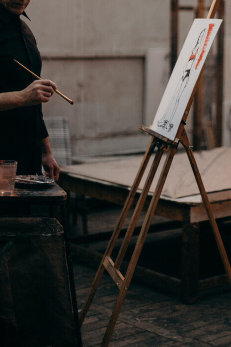 Pittore nella bottega. Sembra quasi la bottega di un artista di quelli che non ci sono più, una bottega di rigattiere sempre impegnato nella creazione
