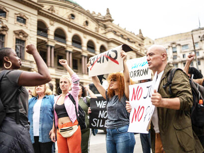 Protesters holding signs during a street demonstration stand united in their call for change, voicing their demands for justice and political reform