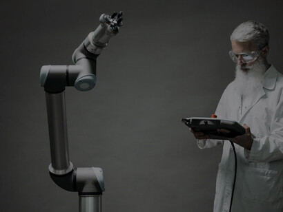 A man conducting research in a lab with robotic technology, showcasing advanced technological expertise