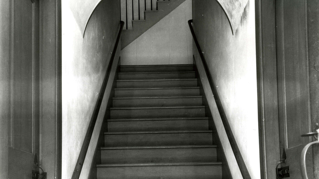 Interior of Meetinghouse, detail of stairway to Ministry’s living quarters, showing doors to brethren’s and sisters’ shoe or cloak rooms on either side (Church Family, Mount Lebanon, New York)
