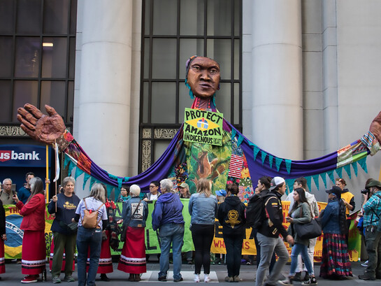 A giant puppet, street mural, and road blockade outside the Brazilian Consulate in San Francisco, California, call on President Jair Bolsonaro to protect the Amazon and respect Indigenous rights