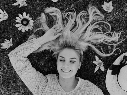 A smiling woman dreams on the grass