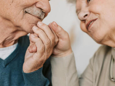 A lovely elderly couple holding hands, sharing a moment of intimacy and connection