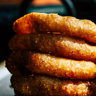 Sel roti is a traditional Nepali rice bread made from a fermented batter and deep-fried into a circular shape