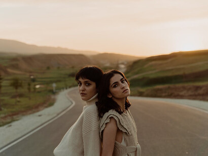 Two friends stand contemplating, revealing their journey of self-discovery, balancing dreams and realities while visualising their unique place in the world