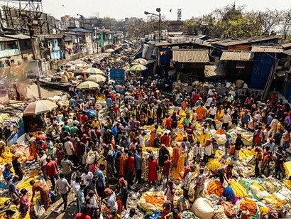 The bustling flower market in Kolkata is teeming with people, creating a vibrant scene in the heart of the city.