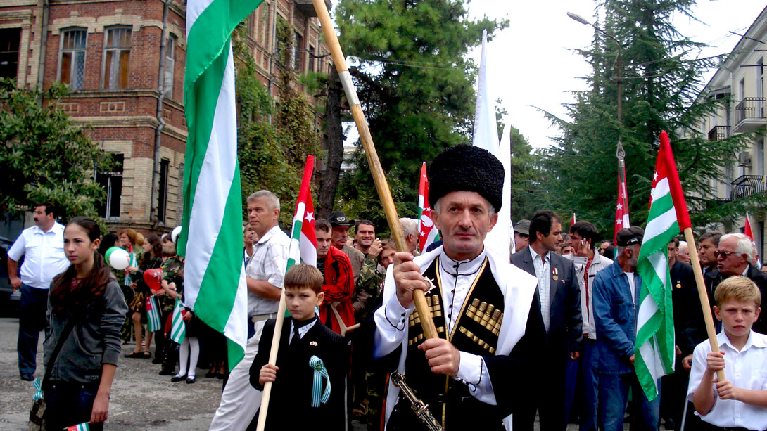 A person from Abkhazia holding the Apsny (Abkhaz) flag