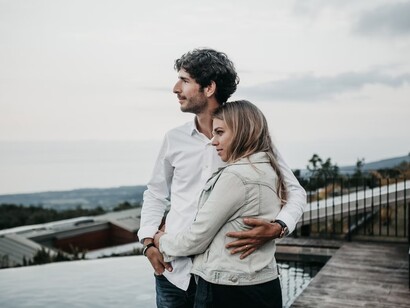 Couple embracing each other, while looking at the landscape, and thinking about the future