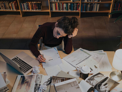 A young woman working overnight on a series of texts