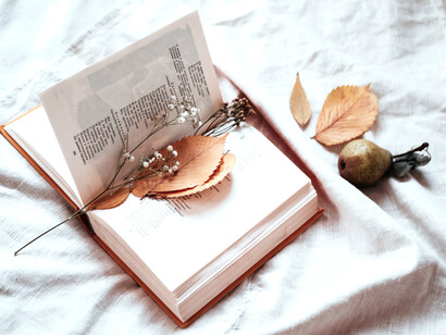 Using leaves and dried flowers as a bookmark in a book
