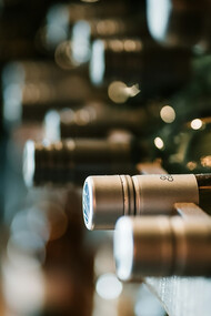 A collection of Tazzelenghe wine bottles neatly lined up, showcasing the wines from Friuli Venezia Giulia