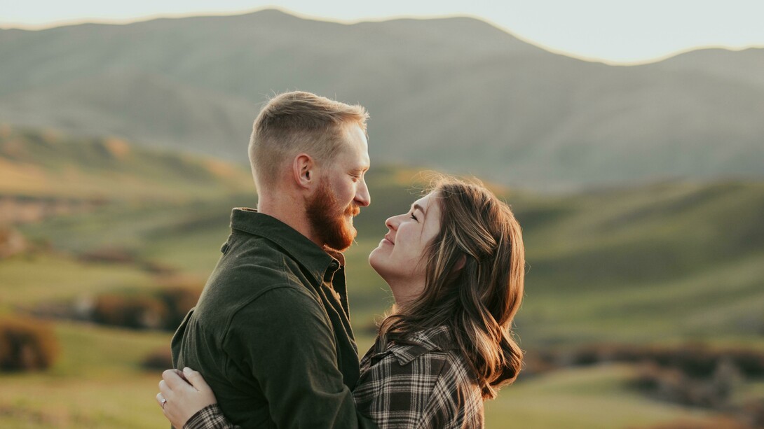 A couple embracing while gazing into each other’s eyes