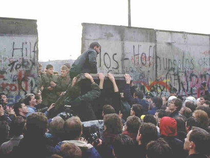 The Berlin Wall was a guarded concrete barrier that physically and ideologically divided Berlin from 1961 to 1989
