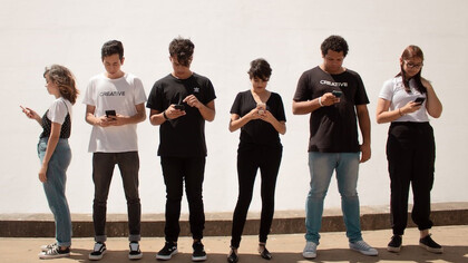 A gathering of individuals engrossed in their mobile phones