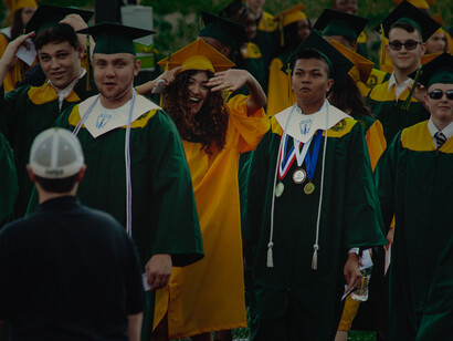 Students celebrating graduation day, cheering and smiling, celebrating success