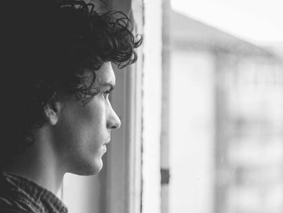 A man with OCD looking out a window 