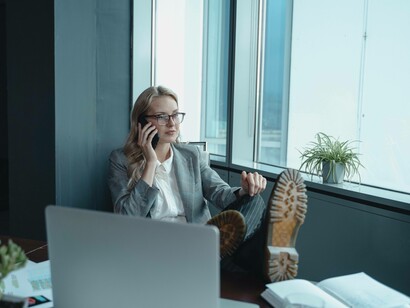 A woman is cementing her purpose while making deals on her phone