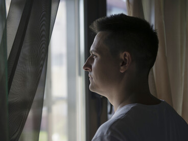Close-up of a man looking outside, suggesting the internal tension and fear that define King’s characters