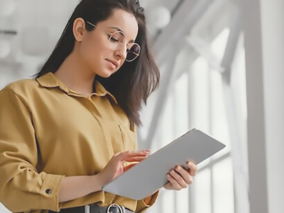 A young businesswoman consulting her tablet for information
