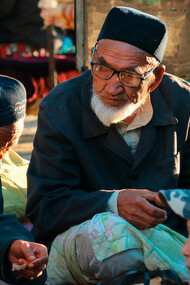 Elderly men and children sitting together, reflecting the warmth and traditions of Uzbek culture in Uzbekistan