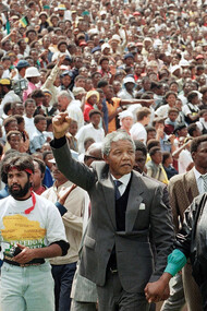 Nelson and Winnie Mandela hold their fists to the sky as ANC supporters cheer on during a rally at the FNB Stadium in Soweto, Johannesburg, held on the 16th of December, 1990, shortly after Nelson Mandela's release from prison