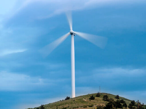 Wind turbines over a green valley in Uzbekistan, harnessing renewable energy for a sustainable future