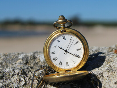 An open vintage watch, its hands immutable