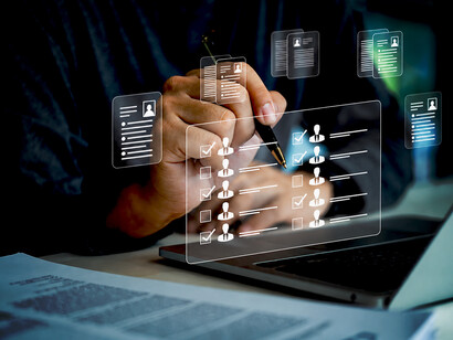 Human resources professional reviewing applicant data and candidate rankings through an AI-driven online recruitment system