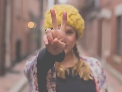 Hopeful woman making a wish gesture on the road