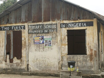 A close-up of the old school facade highlights neglect in education infrastructure 