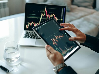 Real-time trading data displayed across connected devices, representing the acceleration of AI-driven fintech operations