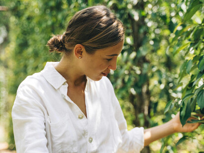 A young woman handling pepper plants