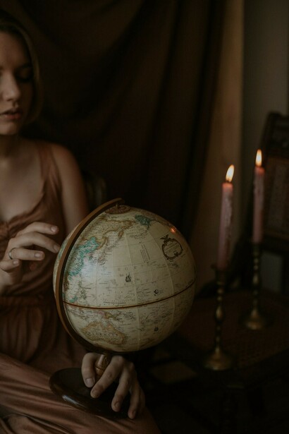 A woman gently holds a globe ball in her hands