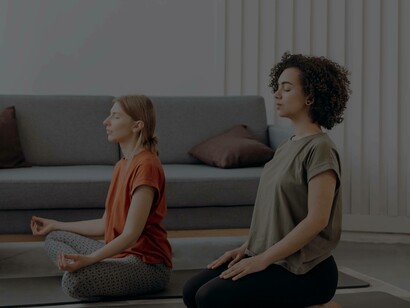 Two women meditating as part of their process to be persistant
