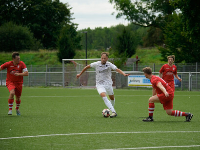 An attacker dribbles on the ball near the opposition's box