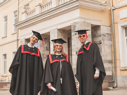 Fresh graduates happily capturing memories with selfies, celebrating their academic success on campus at university