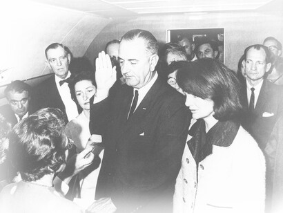 Vice President Lyndon B. Johnson was sworn in after the assassination of JFK, with First Lady Jacqueline Kennedy standing watch after her husband died