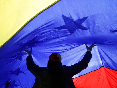 A Venezuelan holds up the flag 