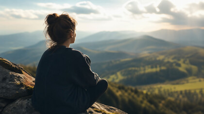 A solitary figure overlooking a vast landscape, reflecting the quiet transformation that begins when the mind opens beyond fear, assumption, and inherited boundaries