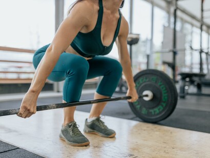 Woman lifting weights at the gym 