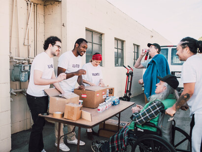 Volunteers handing out supplies to those who need them