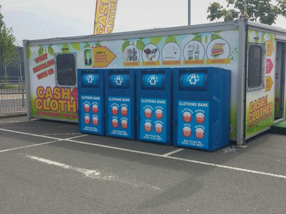 Big dumpsters in a neighborhood parking lot