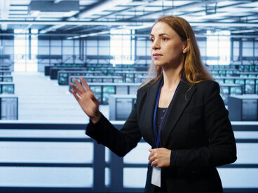 A software developer reviews system visualizations while monitoring data-center infrastructure