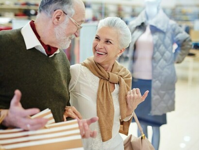 A retired couple enjoying a shopping spree while updating their wardrobe